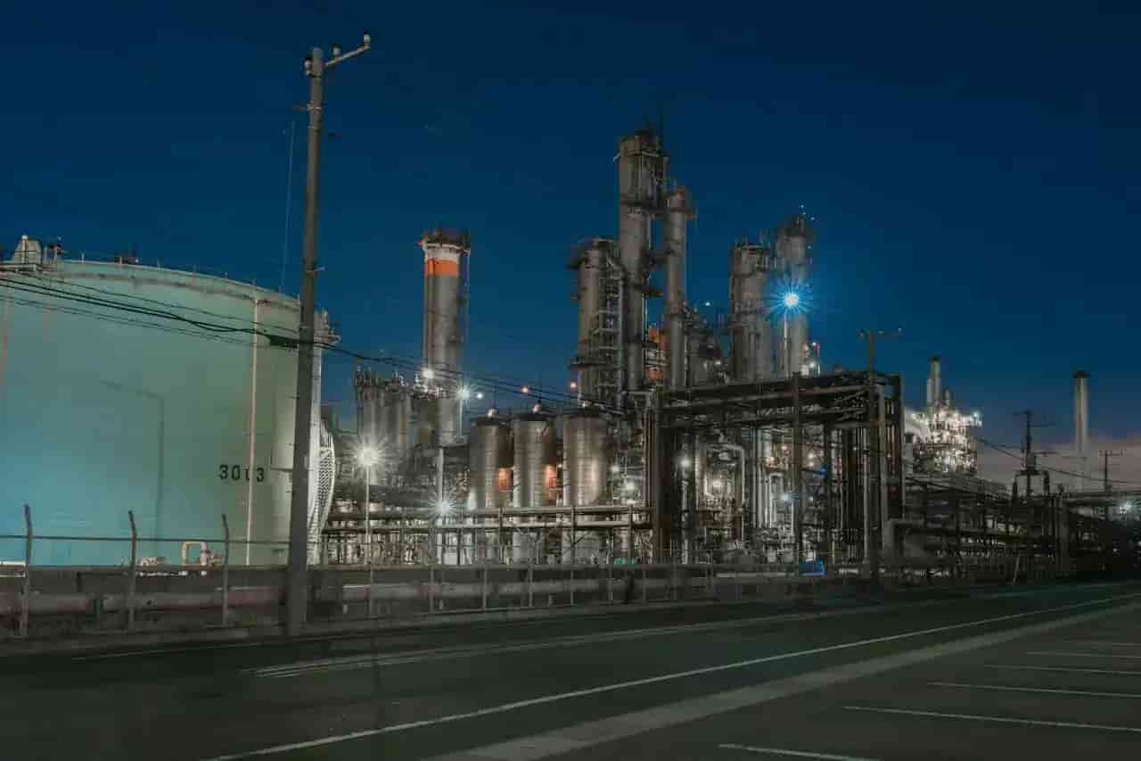 Industrial chemical plant with pipes and process equipment at night