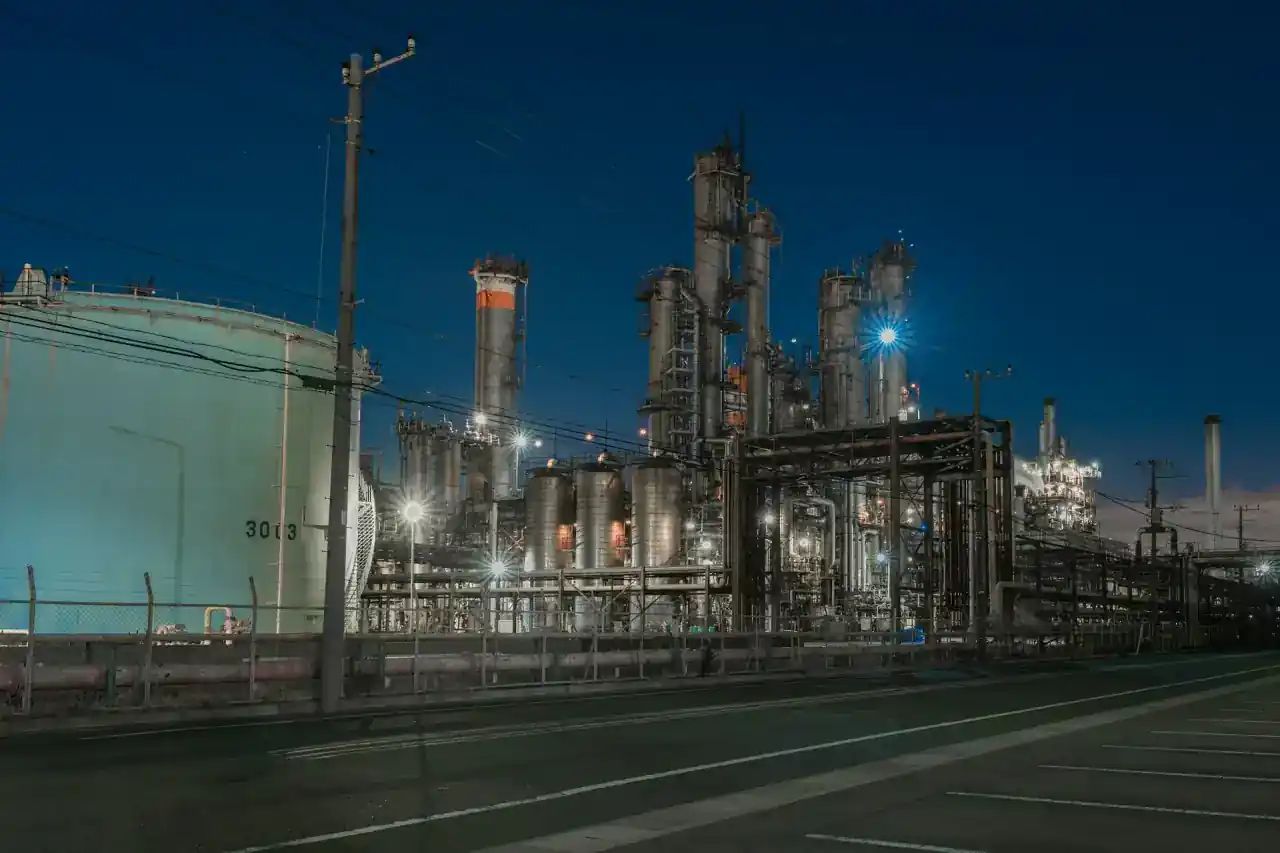 Industrial chemical plant with pipes and process equipment at night